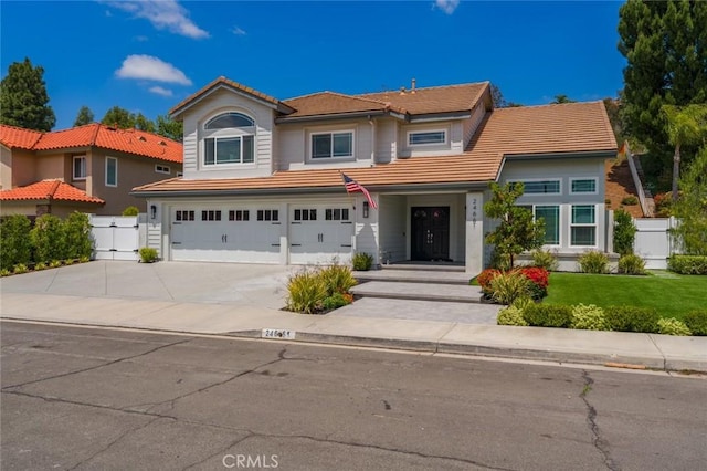 24661 Las Patranas, Yorba Linda, CA 92887 - traditional-style home featuring fence, an attached garage, a front lawn, a tile roof, and driveway