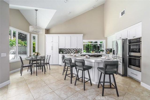 24661 Las Patranas, Yorba Linda, CA 92887 - kitchen with backsplash, white cabinetry, high vaulted ceiling, and appliances with stainless steel finishes