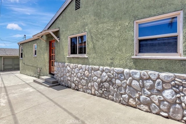 34605 Calle Portola, Dana Point, CA 92624 - view of side of property featuring an outdoor structure, stucco siding, and entry steps