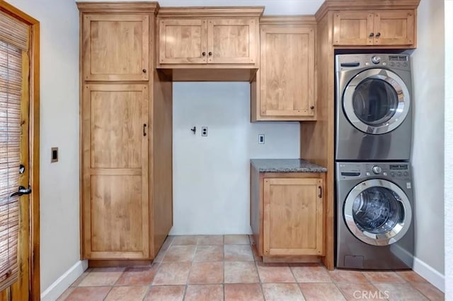 34605 Calle Portola, Dana Point, CA 92624 - clothes washing area with baseboards, cabinet space, and stacked washer / drying machine