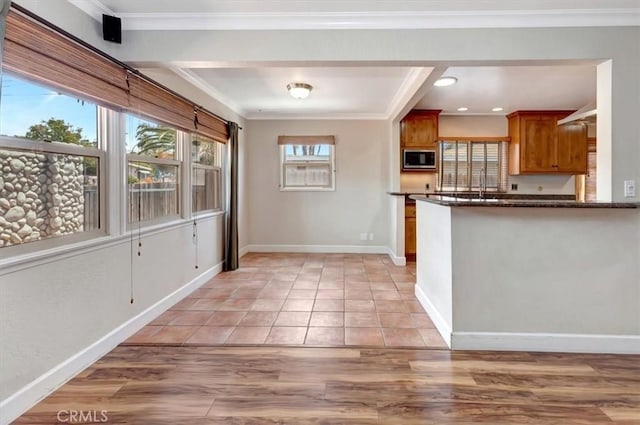 34605 Calle Portola, Dana Point, CA 92624 - kitchen with crown molding, built in microwave, brown cabinets, baseboards, and light wood finished floors