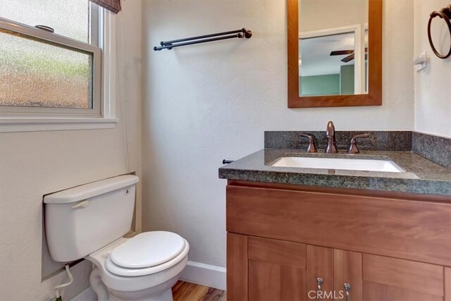 34605 Calle Portola, Dana Point, CA 92624 - bathroom featuring toilet, baseboards, wood finished floors, and vanity