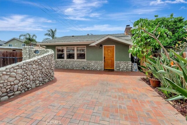 34605 Calle Portola, Dana Point, CA 92624 - exterior space with fence, a chimney, stone siding, and stucco siding