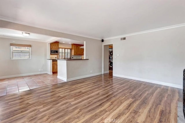 34605 Calle Portola, Dana Point, CA 92624 - unfurnished living room featuring baseboards, visible vents, ornamental molding, and light wood finished floors