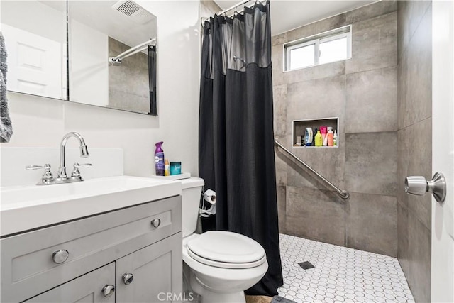full bath featuring visible vents, a tile shower, toilet, and vanity