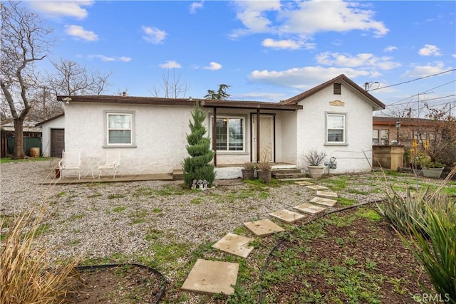 rear view of property with stucco siding