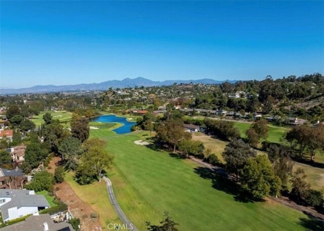 aerial view featuring a residential view, view of golf course, and a water and mountain view