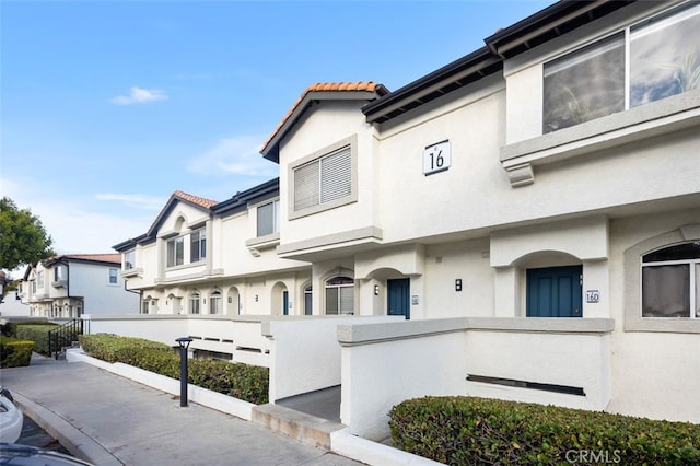 30902 Clubhouse Dr Unit 16H, Laguna Niguel, CA 92677 - view of front of home featuring a tile roof and stucco siding