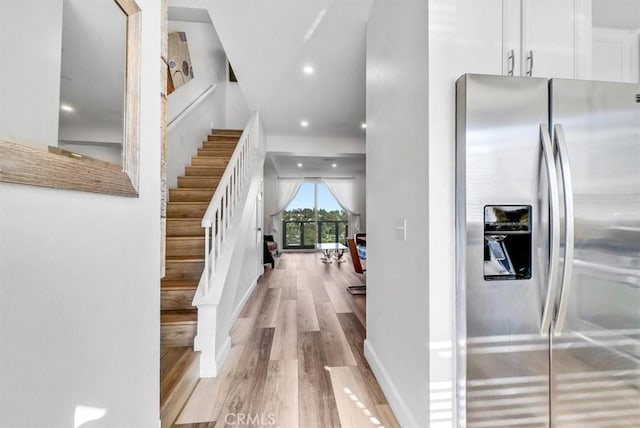 interior space with recessed lighting, wood finished floors, and stairway