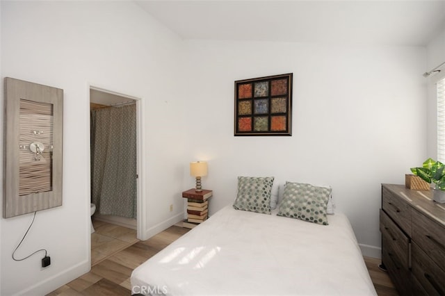 bedroom featuring baseboards and wood finished floors