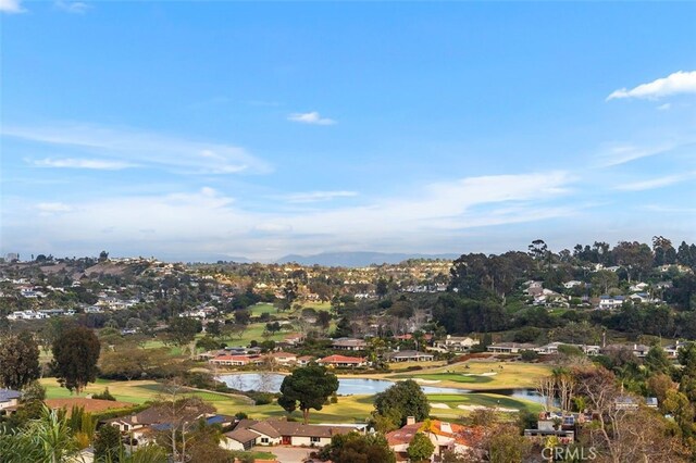 birds eye view of property with a water view, a residential view, and golf course view