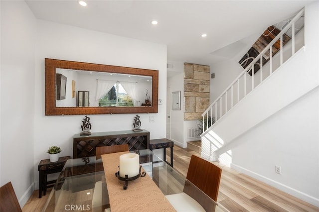 dining room with stairway, baseboards, recessed lighting, and wood finished floors