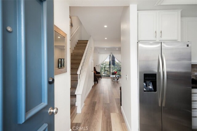 foyer with stairway, recessed lighting, and light wood finished floors