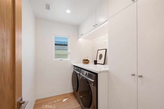207 Canal St, Newport Beach, CA 92663 - laundry area featuring cabinet space, light wood-style floors, independent washer and dryer, and recessed lighting