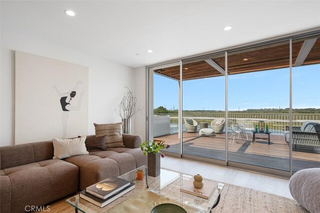 207 Canal St, Newport Beach, CA 92663 - living room with expansive windows, recessed lighting, and wood finished floors