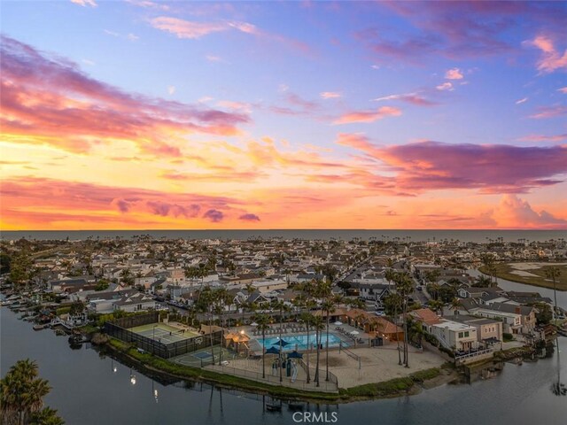 207 Canal St, Newport Beach, CA 92663 - aerial view at dusk of a water view, a residential view, and view of pool