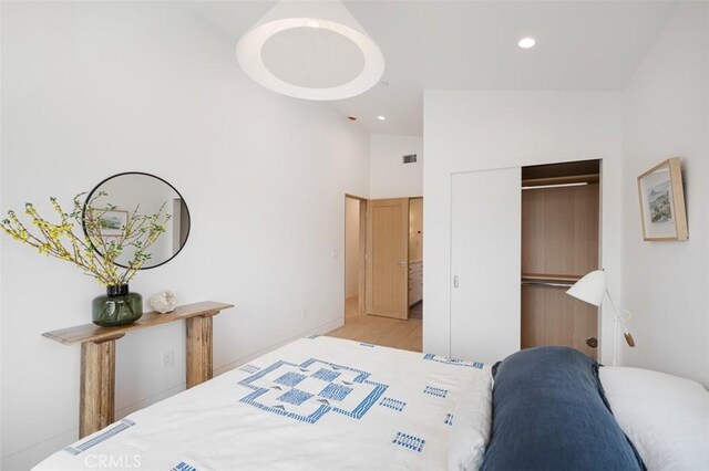 207 Canal St, Newport Beach, CA 92663 - bedroom with a closet, wood finished floors, recessed lighting, and high vaulted ceiling