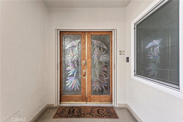 doorway to property with french doors and stucco siding