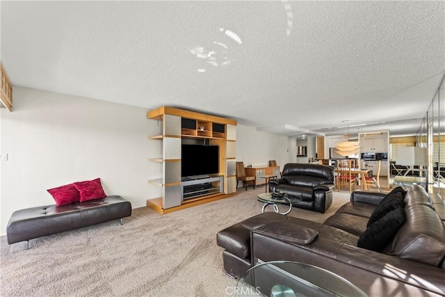 carpeted living room featuring a textured ceiling