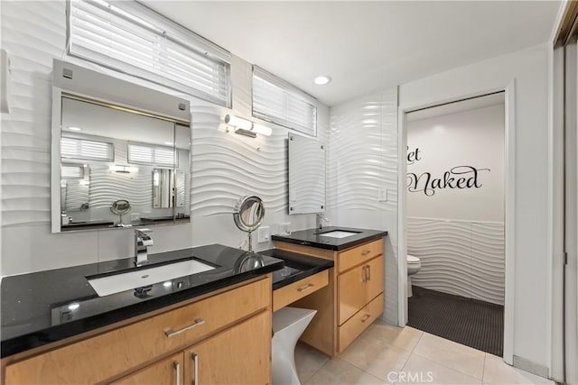 full bathroom featuring toilet, tile patterned flooring, and vanity