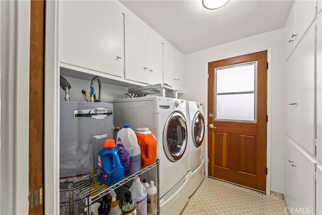 clothes washing area with cabinet space and washer and dryer