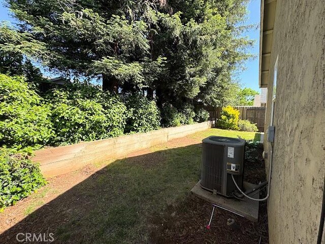 view of yard with fence and cooling unit