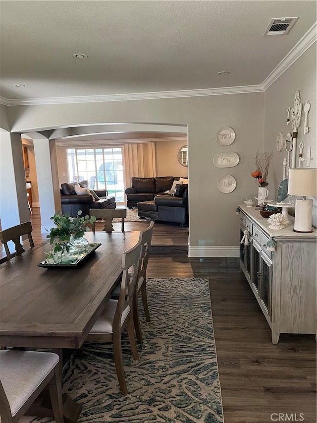 305 W 23rd St, Upland, CA 91784 - dining area featuring baseboards, visible vents, ornamental molding, and dark wood-type flooring