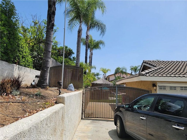305 W 23rd St, Upland, CA 91784 - exterior space featuring stucco siding, a gate, fence, and a tile roof