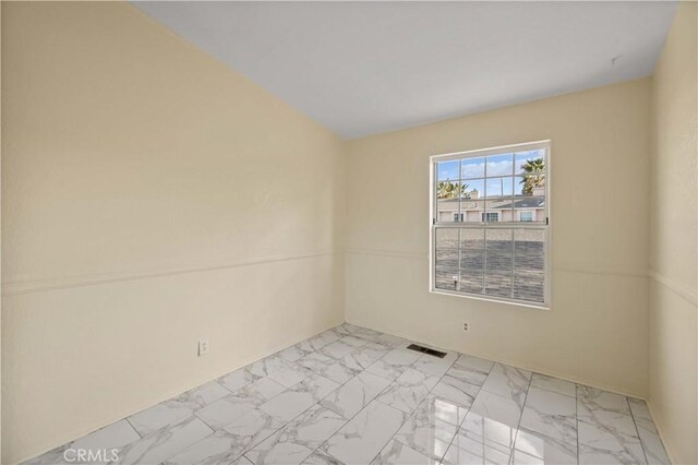 unfurnished room with visible vents and marble finish floor