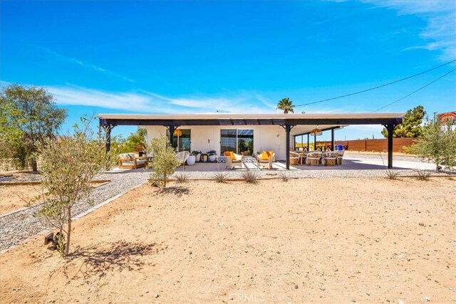 back of property with outdoor lounge area and a patio area