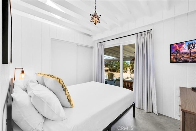 2837 Border Ave, Joshua Tree, CA 92252 - bedroom with access to exterior, concrete flooring, beam ceiling, and a closet