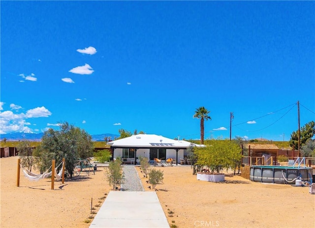 2837 Border Ave, Joshua Tree, CA 92252 - rear view of property with an outdoor pool and fence