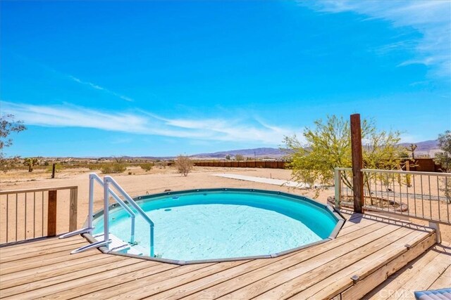 outdoor pool with a deck with mountain view
