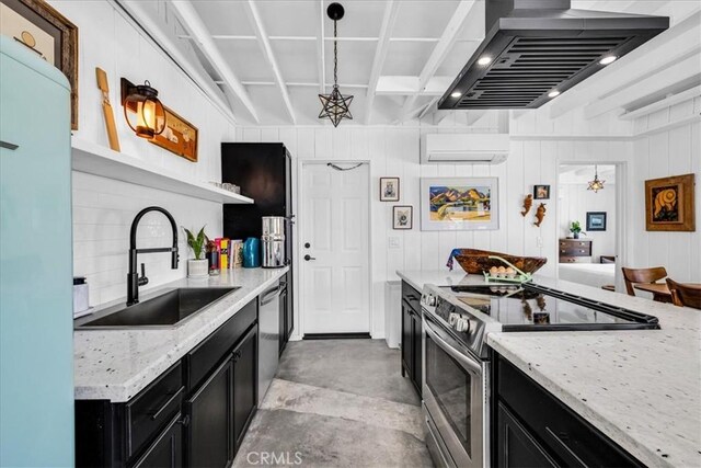 kitchen with wall chimney range hood, appliances with stainless steel finishes, a sink, an AC wall unit, and dark cabinets