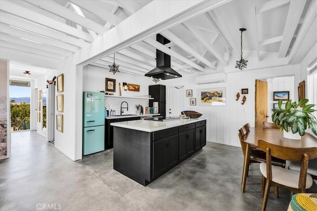 2837 Border Ave, Joshua Tree, CA 92252 - kitchen with dark cabinets, island exhaust hood, concrete flooring, light countertops, and a wall unit AC