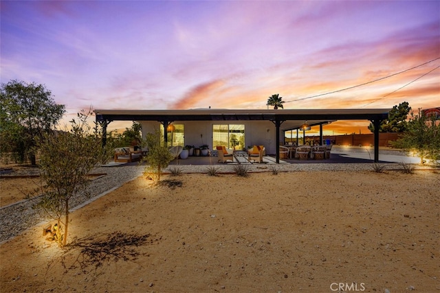 2837 Border Ave, Joshua Tree, CA 92252 - back of property at dusk with a patio