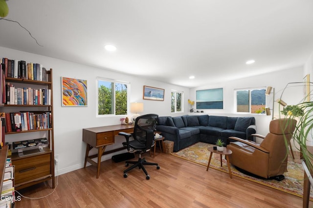 living room featuring recessed lighting, baseboards, and wood finished floors