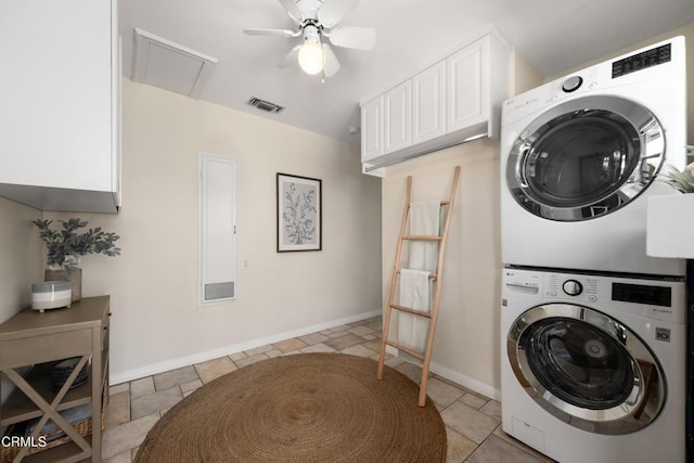 washroom with attic access, a ceiling fan, baseboards, visible vents, and stacked washer and clothes dryer