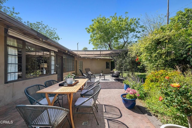view of patio with a pergola and outdoor dining area