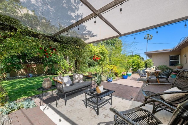 view of patio / terrace featuring fence, outdoor dining area, and an outdoor hangout area