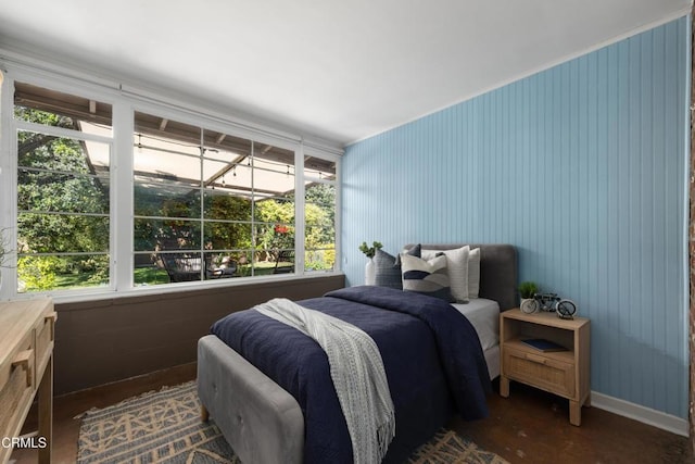 bedroom with multiple windows and wood finished floors