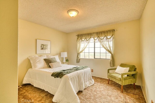 bedroom with carpet flooring and a textured ceiling