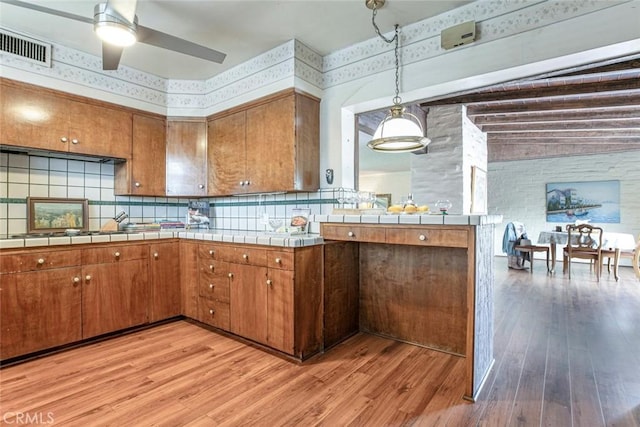 1422 W Riverside Dr, Burbank, CA 91506 - kitchen with tile counters, brown cabinetry, and light wood-type flooring