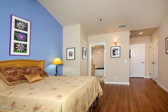 bedroom with visible vents, connected bathroom, baseboards, and dark wood-type flooring