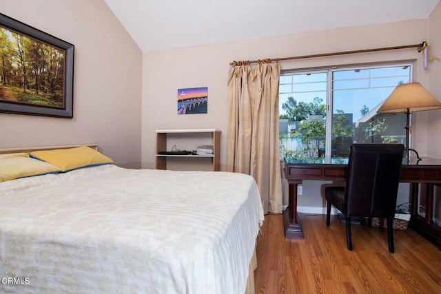 bedroom featuring vaulted ceiling and wood finished floors