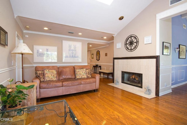 living area with visible vents, crown molding, wood finished floors, lofted ceiling, and recessed lighting