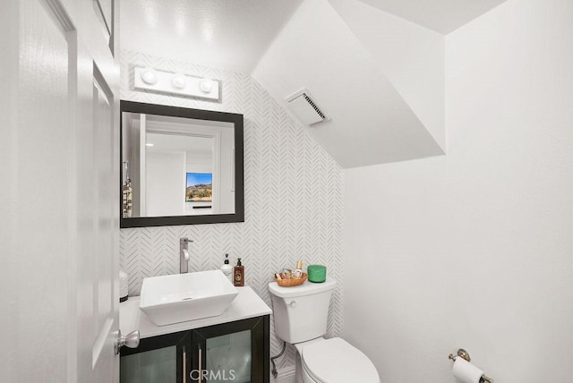 30 Starfish Ct Unit 14, Newport Beach, CA 92663 - half bathroom featuring toilet, tile walls, vanity, and visible vents