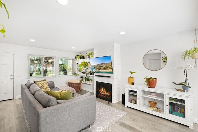 30 Starfish Ct Unit 14, Newport Beach, CA 92663 - living area featuring a large fireplace, recessed lighting, baseboards, and wood finished floors