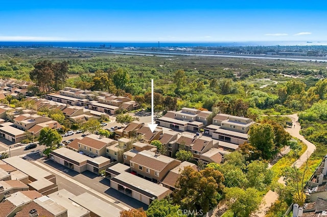 drone / aerial view featuring a residential view and a forest view