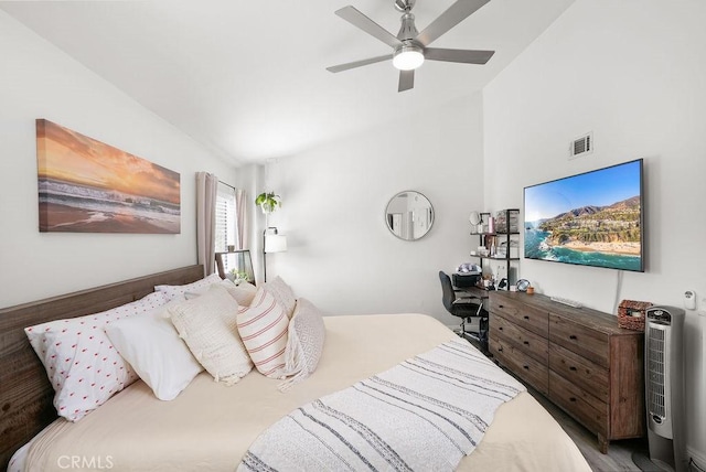 bedroom with ceiling fan, visible vents, and vaulted ceiling